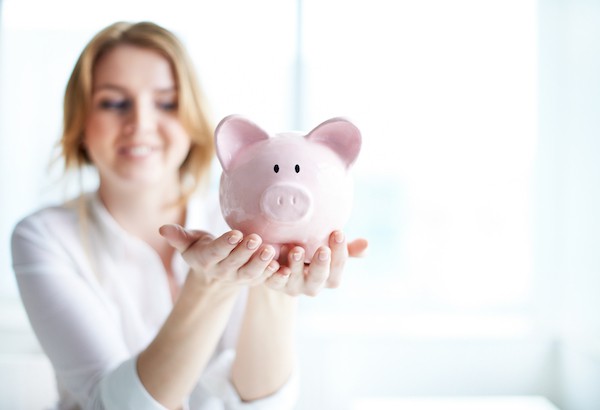 Image of pink piggy bank held by female